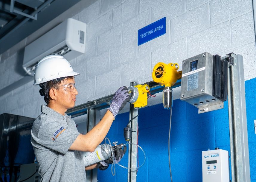 AIC technician calibrating a fixed gas detector in the Al Khobar testing area