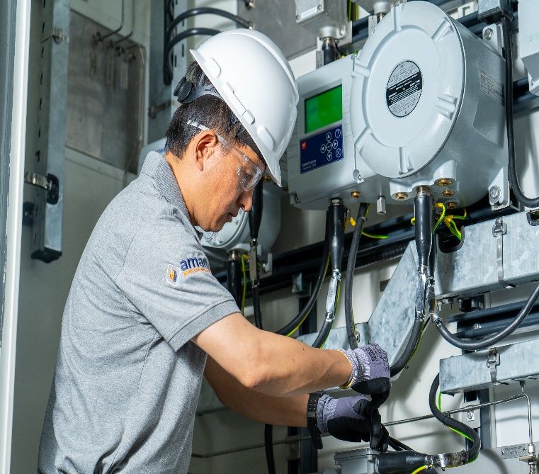 AIC technician servicing analyzer equipment inside an analyzer shelter