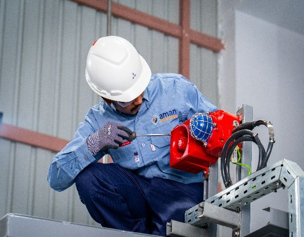 AIC engineer inspecting electrical equipment mounted on a cable tray